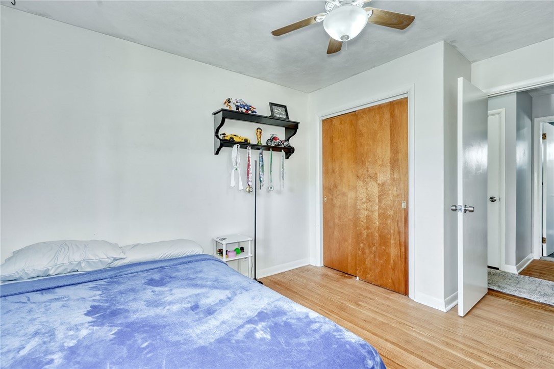 1038 Whalen Road Penfield, NY 14526 - Photo 21 of 46 Bedroom number one with ceiling, fan and hardwood