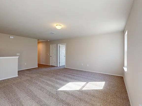 12112 Dillon Fls Drive Austin, TX 78747 - Photo 12 of 31 Empty room featuring carpet flooring and baseboards