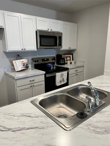 a living room with kitchen island furniture and a wooden floor