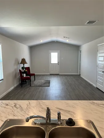 a kitchen with stainless steel appliances granite countertop a sink and a stove