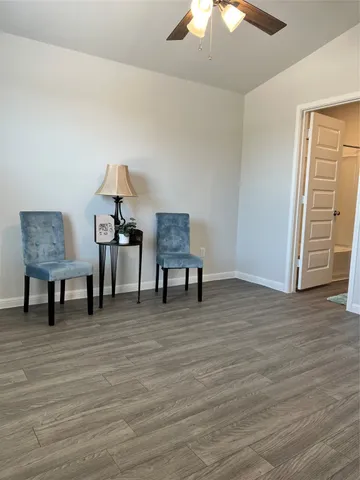 a view of a room with wooden floor a bathroom and bathroom