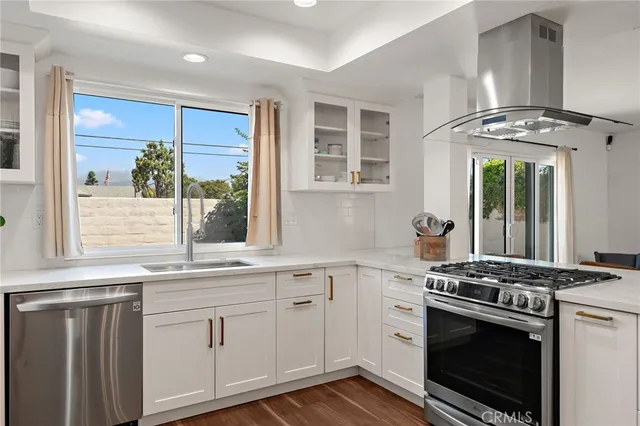 a kitchen with granite countertop a sink stainless steel appliances and cabinets