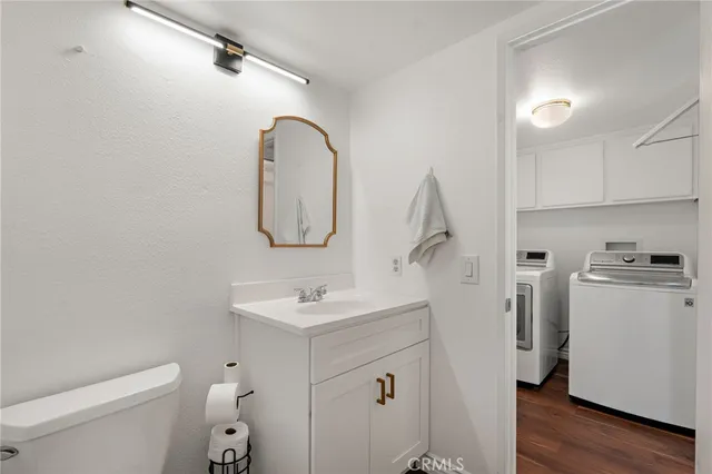 a bathroom with a sink a toilet and a mirror