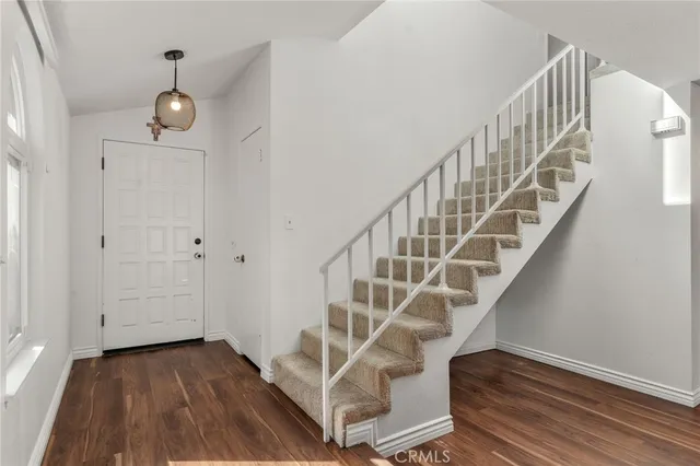 a view of entryway and hall with wooden floor