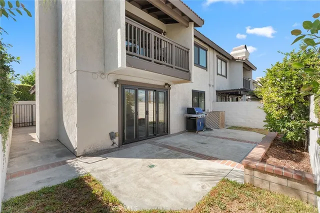 a view of a patio with couches table and chairs and potted plants
