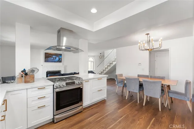 a kitchen with a stove and white cabinets