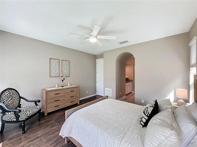 a spacious bedroom with a bed and a large window