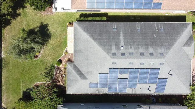 an aerial view of residential houses with outdoor space and ocean view