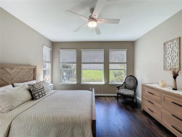 a bathroom with a granite countertop sink a mirror and a shower