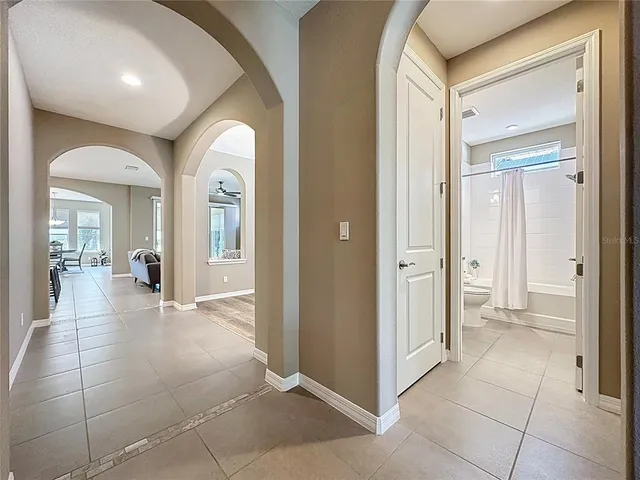 a kitchen with stainless steel appliances kitchen island granite countertop a refrigerator and a stove top oven