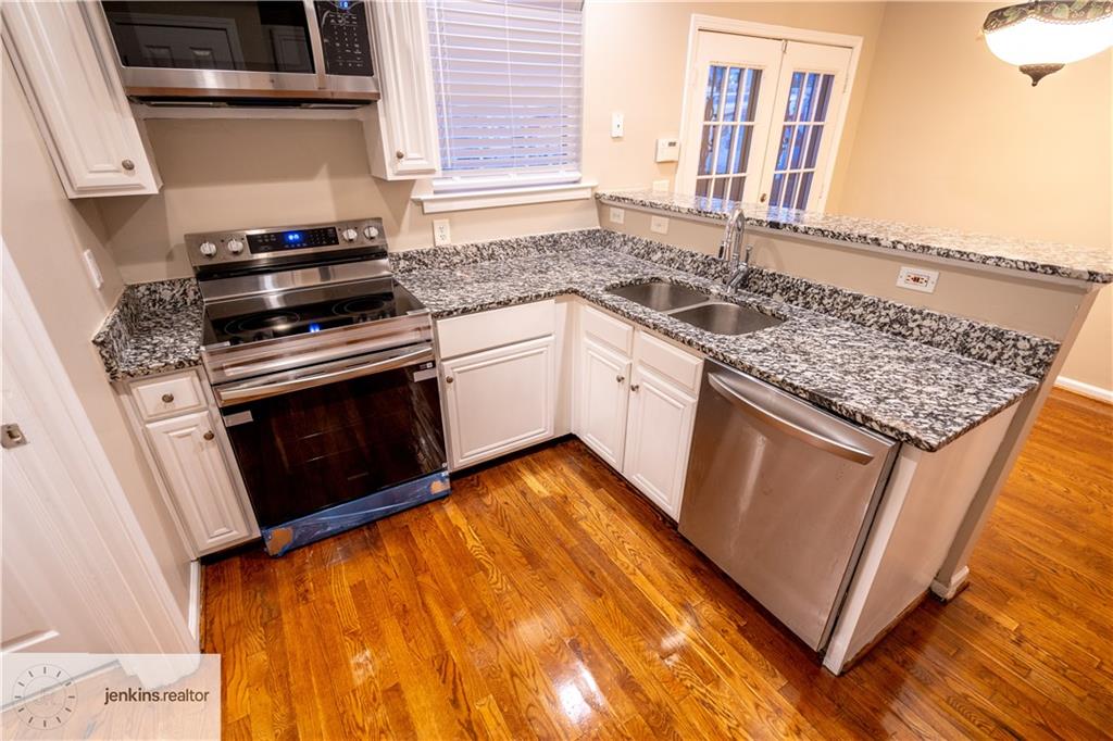 1188 Ira Street Southwest Atlanta, GA 30310 - Photo 13 of 33 a kitchen with granite countertop stainless steel appliances and wooden cabinets
