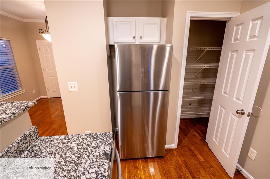 1188 Ira Street Southwest Atlanta, GA 30310 - Photo 16 of 33 a view of walk in closet with wooden floor and cabinet