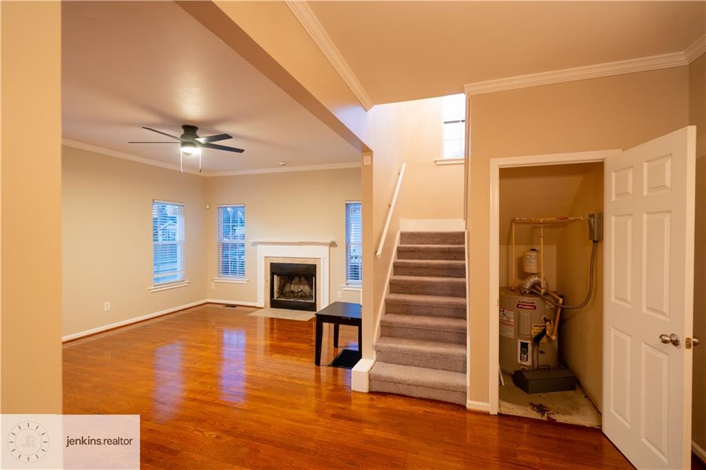 1188 Ira Street Southwest Atlanta, GA 30310 - Photo 5 of 33 a view of a livingroom with wooden floor and a ceiling fan