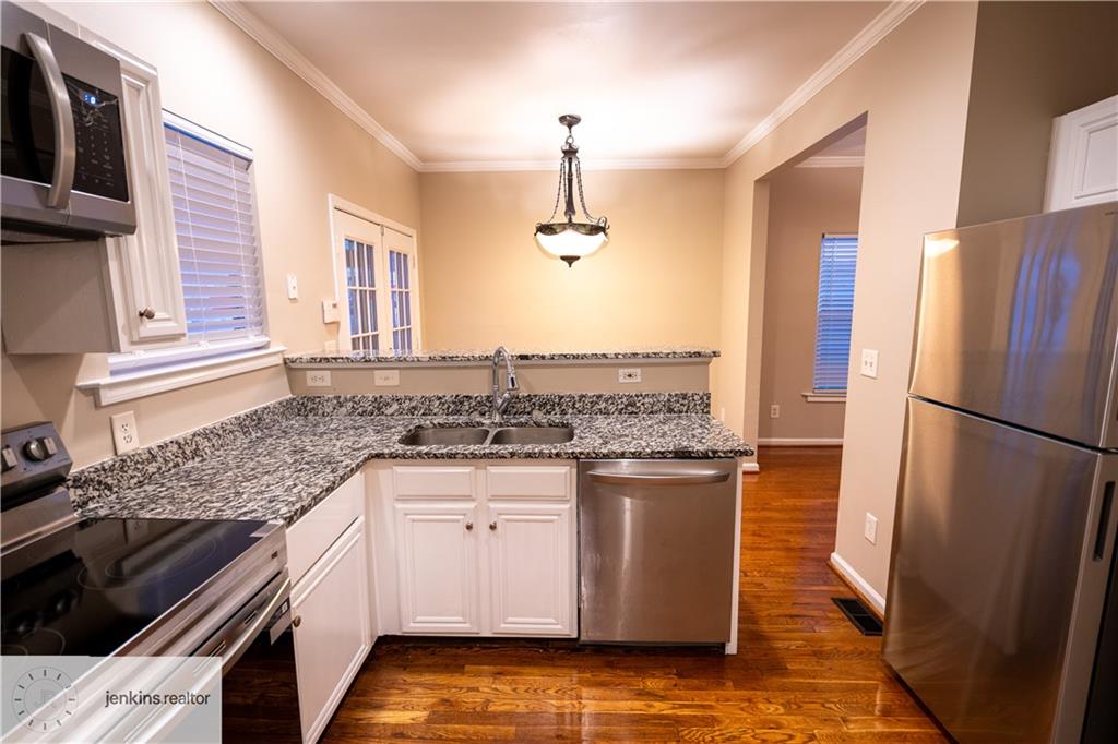 1188 Ira Street Southwest Atlanta, GA 30310 - Photo 8 of 33 a kitchen with stainless steel appliances granite countertop a sink stove and refrigerator