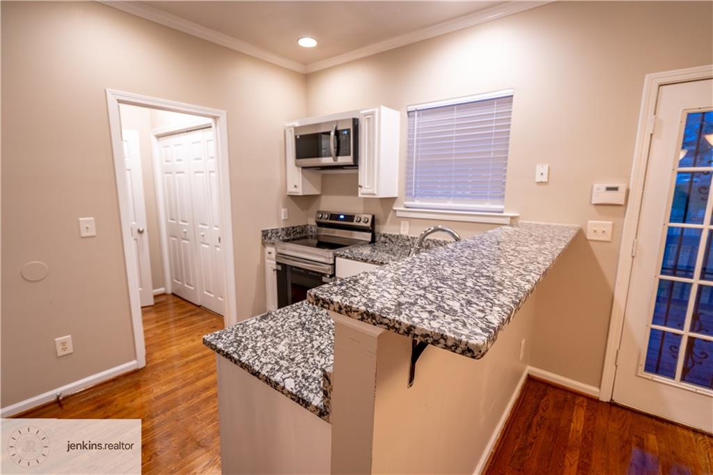 1188 Ira Street Southwest Atlanta, GA 30310 - Photo 10 of 33 a kitchen with stainless steel appliances granite countertop refrigerator sink and microwave