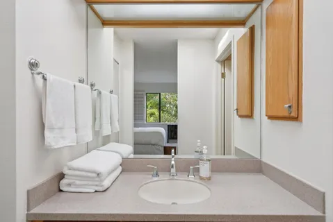 a bathroom with a double vanity sink and a mirror