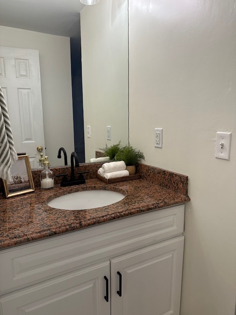 100 Rising Trail Drive, Unit 100 Middletown, CT 06457 - Photo 16 of 33 a bathroom with a granite countertop sink and a mirror