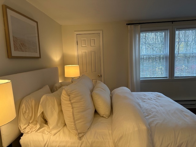 100 Rising Trail Drive, Unit 100 Middletown, CT 06457 - Photo 20 of 33 a bedroom with a bed and a window