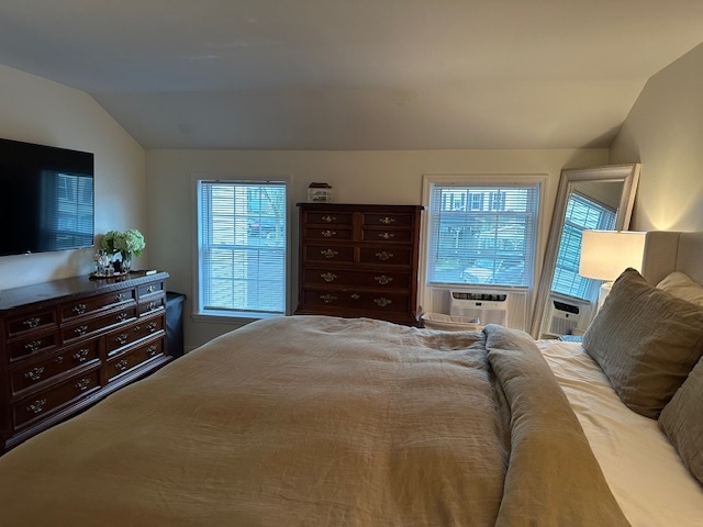 100 Rising Trail Drive, Unit 100 Middletown, CT 06457 - Photo 22 of 33 a bed sitting in a spacious bedroom next to a window and dresser