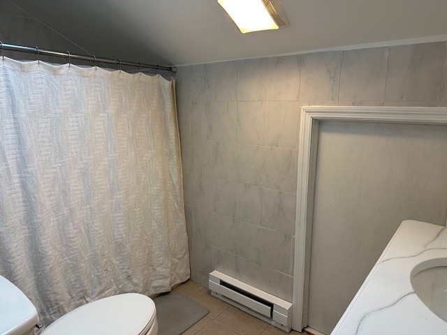 100 Rising Trail Drive, Unit 100 Middletown, CT 06457 - Photo 26 of 33 a white toilet sitting next to a shower curtain