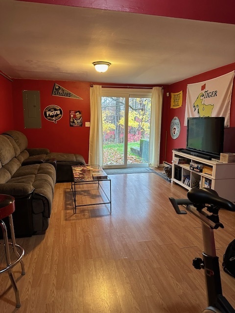 100 Rising Trail Drive, Unit 100 Middletown, CT 06457 - Photo 32 of 33 a living room with furniture flat screen tv and wooden floor