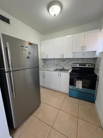 a kitchen with cabinets and steel stainless steel appliances