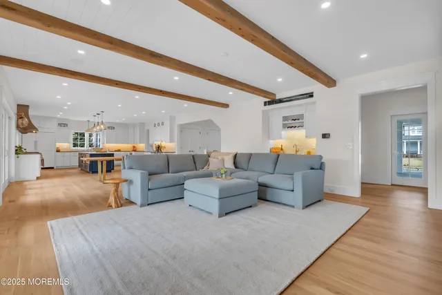 a view of a hallway with wooden floor and entryway