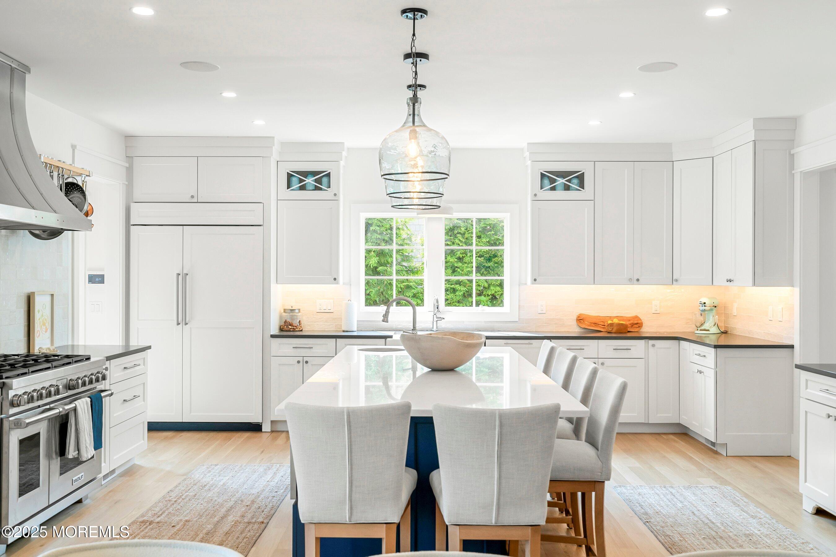 205 Morris Avenue Spring Lake, NJ 07762 - Photo 16 of 105 a kitchen with stainless steel appliances granite countertop a stove a sink dishwasher a dining table and chairs with wooden floor
