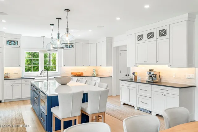 a bathroom with a double vanity sink toilet and shower