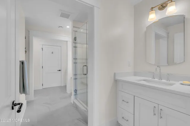 a kitchen with stainless steel appliances a table a stove and a wooden floors