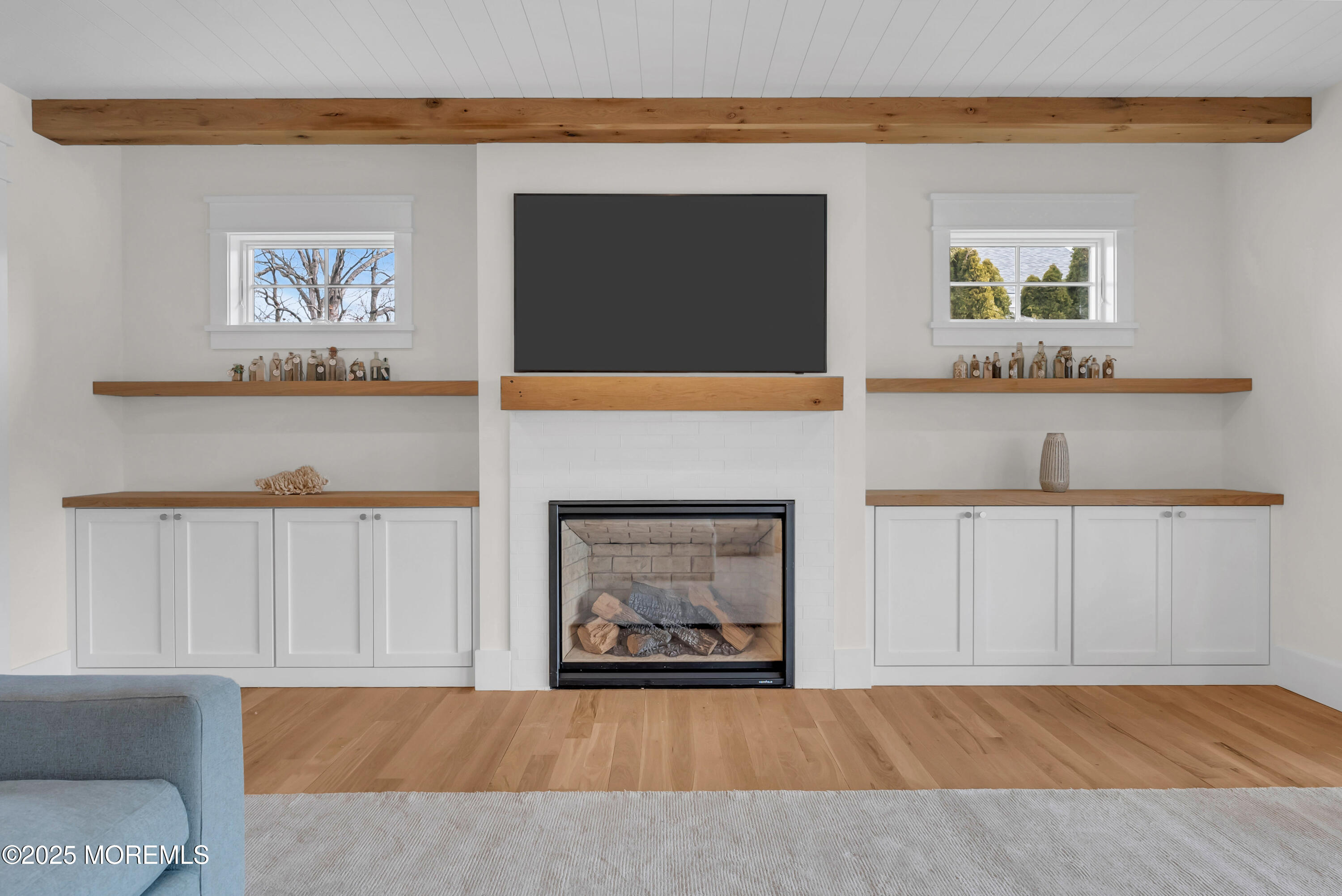 205 Morris Avenue Spring Lake, NJ 07762 - Photo 68 of 105 a living room with a fireplace and a flat screen tv