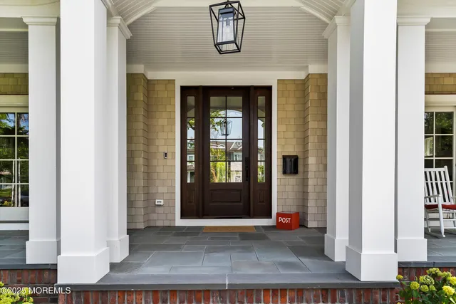 a living room with furniture a wooden floor and a large window