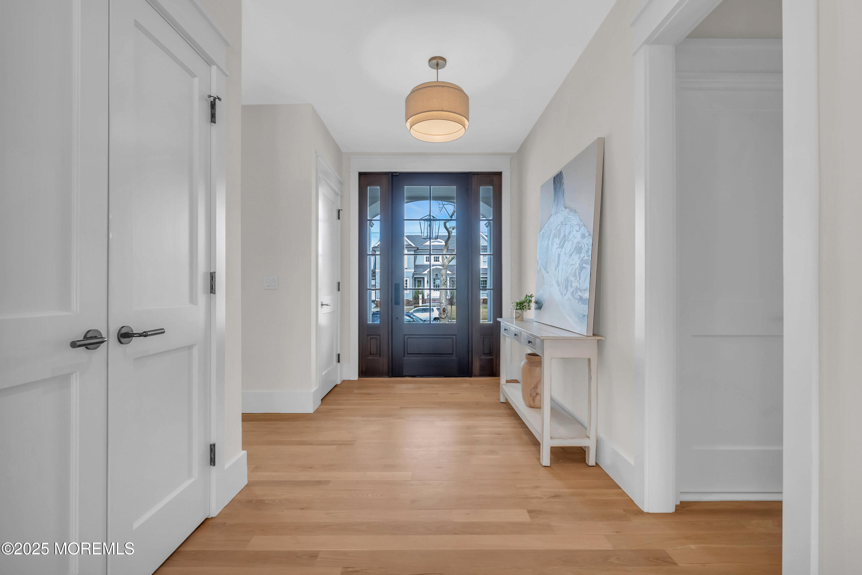 205 Morris Avenue Spring Lake, NJ 07762 - Photo 9 of 105 a view of a hallway with wooden floor and a bathroom
