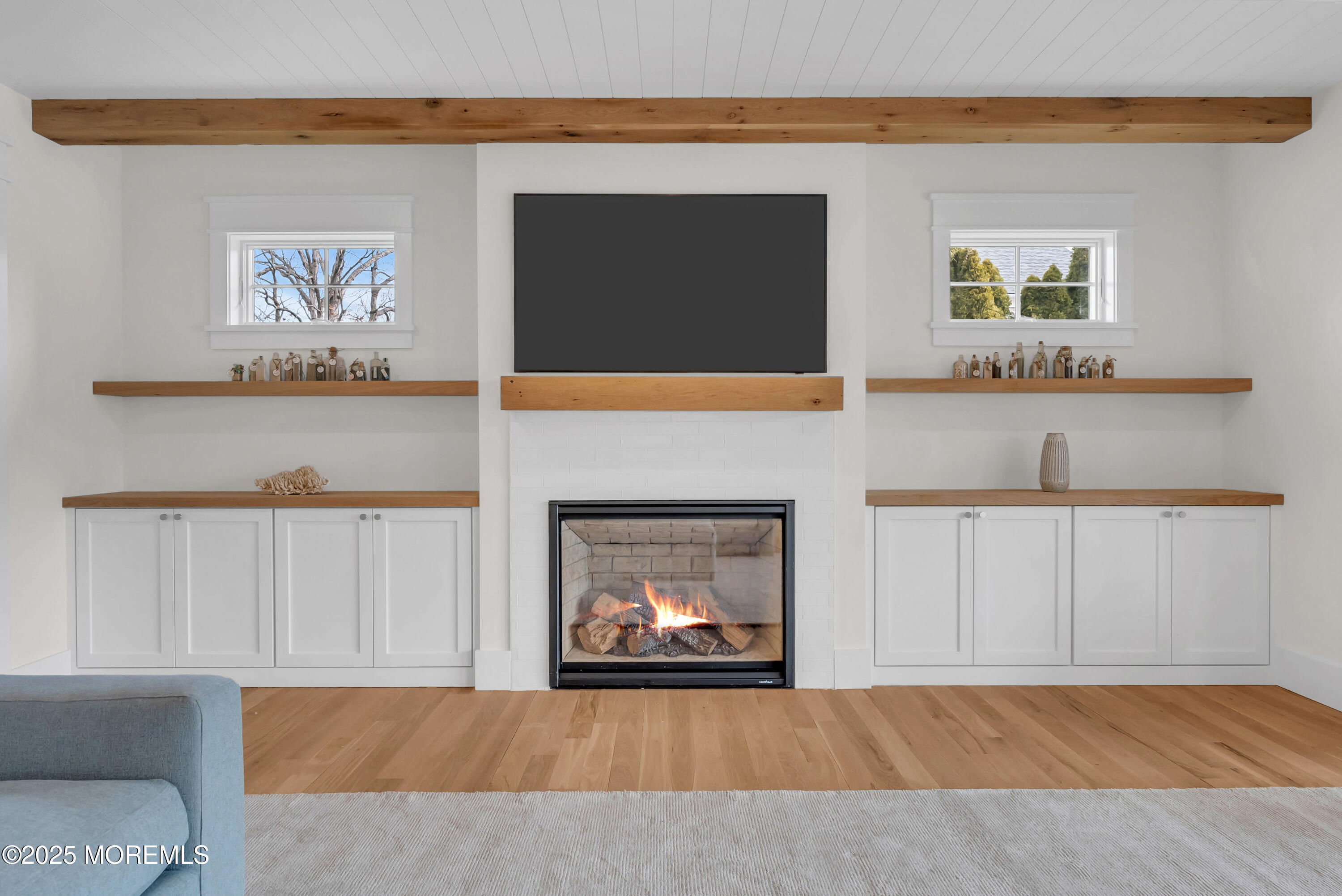 205 Morris Avenue Spring Lake, NJ 07762 - Photo 93 of 105 a living room with a fireplace and a flat screen tv