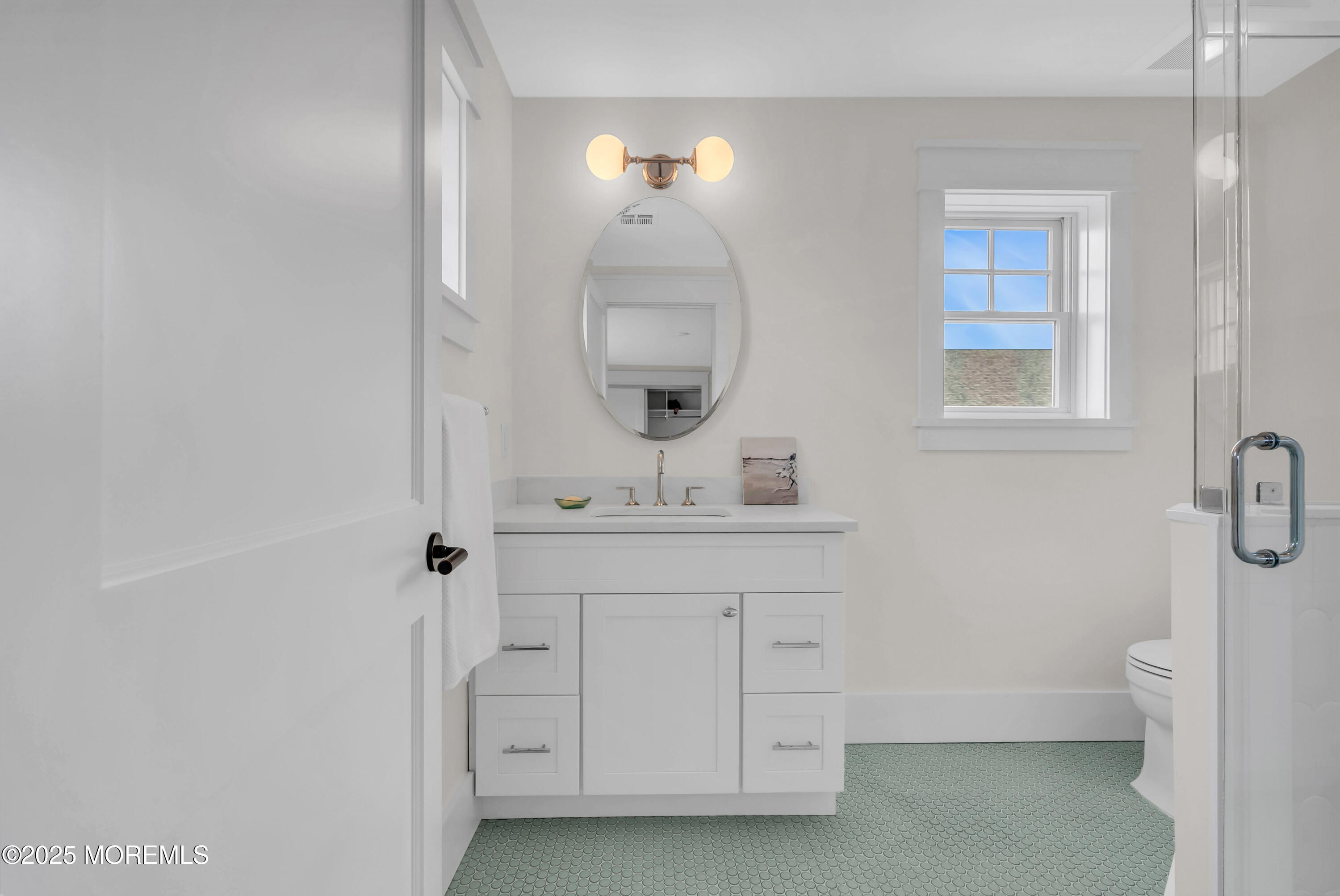 205 Morris Avenue Spring Lake, NJ 07762 - Photo 96 of 105 a bathroom with a sink a toilet and a mirror