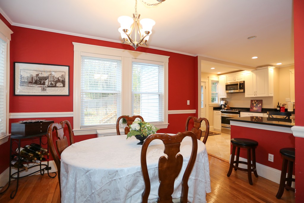 275 Broad Meadow Road Needham, MA 02492 - Photo 12 of 26 a dining room with furniture a window and a chandelier