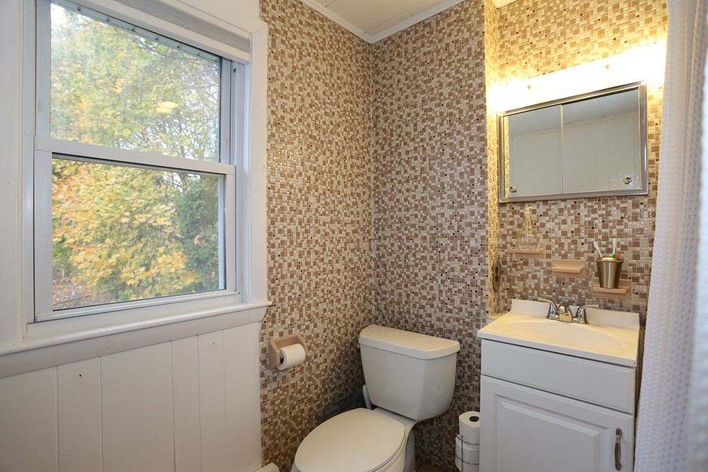 275 Broad Meadow Road Needham, MA 02492 - Photo 23 of 26 a bathroom with a toilet sink and mirror