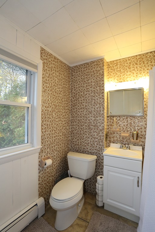 275 Broad Meadow Road Needham, MA 02492 - Photo 25 of 26 a bathroom with a toilet sink and mirror