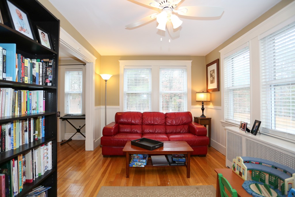 275 Broad Meadow Road Needham, MA 02492 - Photo 7 of 26 a living room with furniture a bookshelf and a window