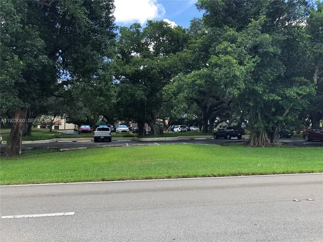 a view of house with yard and trees