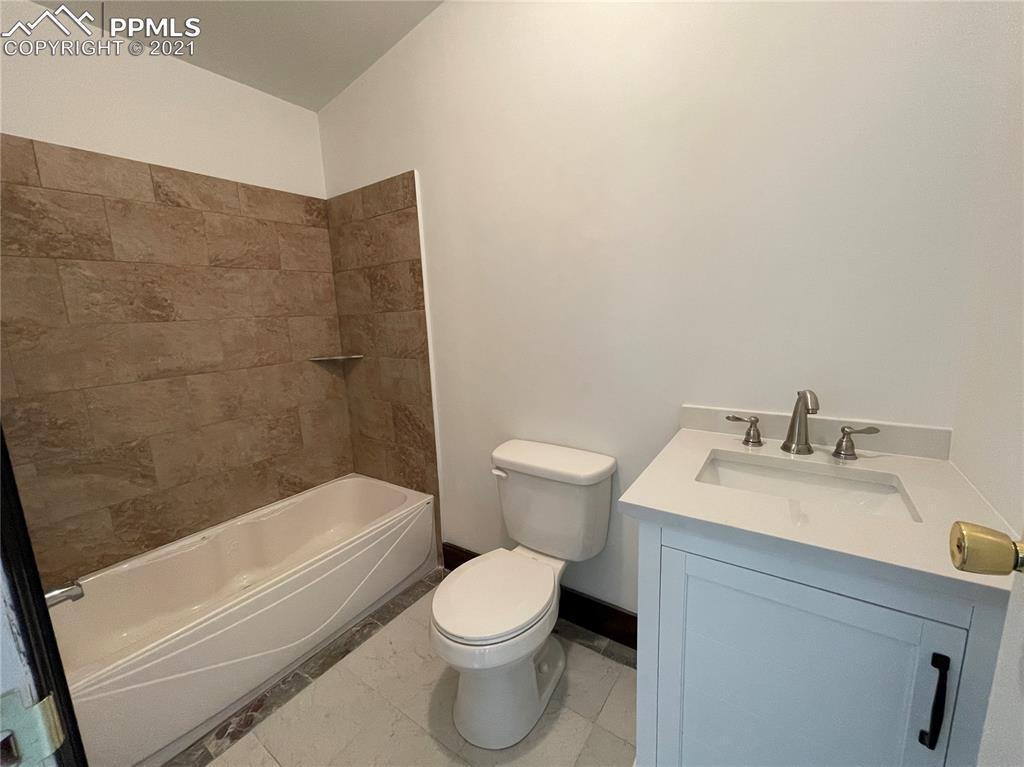 7540 Boone Road Yoder, CO 80864 - Photo 15 of 31 a bathroom with a sink toilet and bathtub