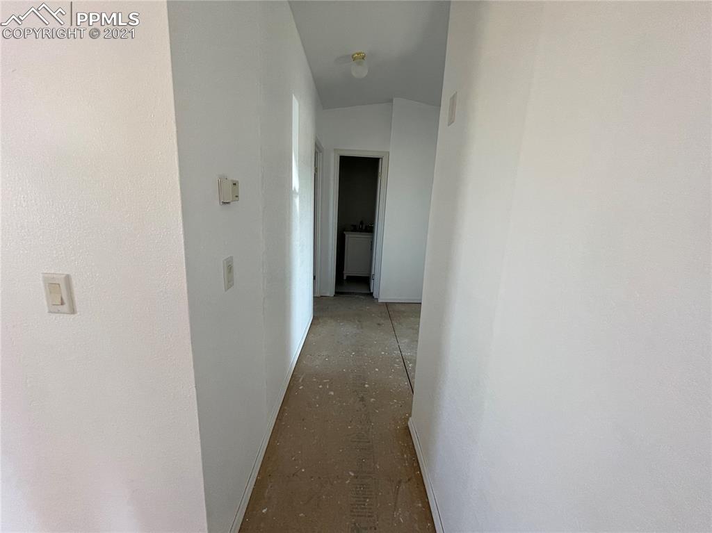 7540 Boone Road Yoder, CO 80864 - Photo 18 of 31 a view of a hallway with wooden floor