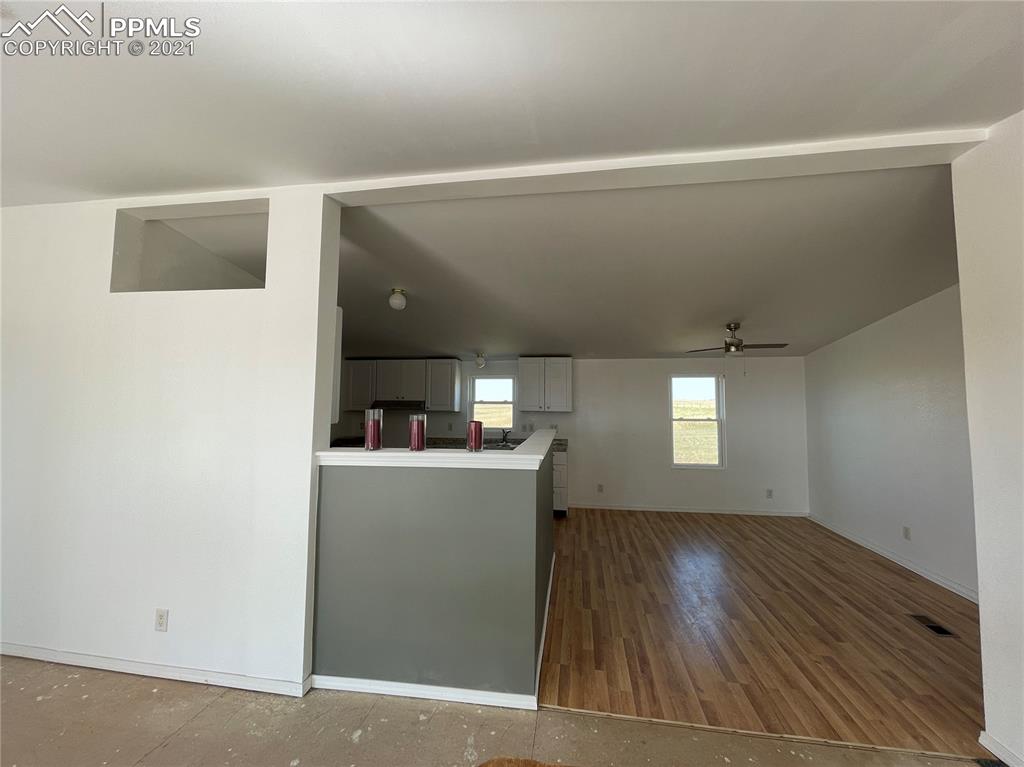 7540 Boone Road Yoder, CO 80864 - Photo 22 of 31 a view of a room with wooden floor and staircase