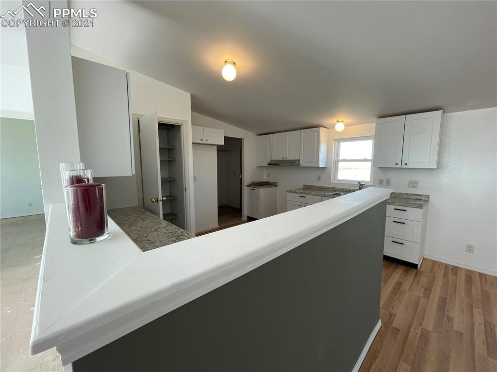 7540 Boone Road Yoder, CO 80864 - Photo 9 of 31 a kitchen with stainless steel appliances a refrigerator sink and cabinets