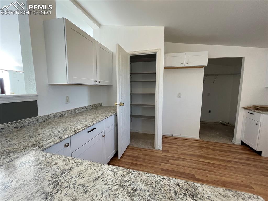 7540 Boone Road Yoder, CO 80864 - Photo 10 of 31 a kitchen with granite countertop a refrigerator and cabinets