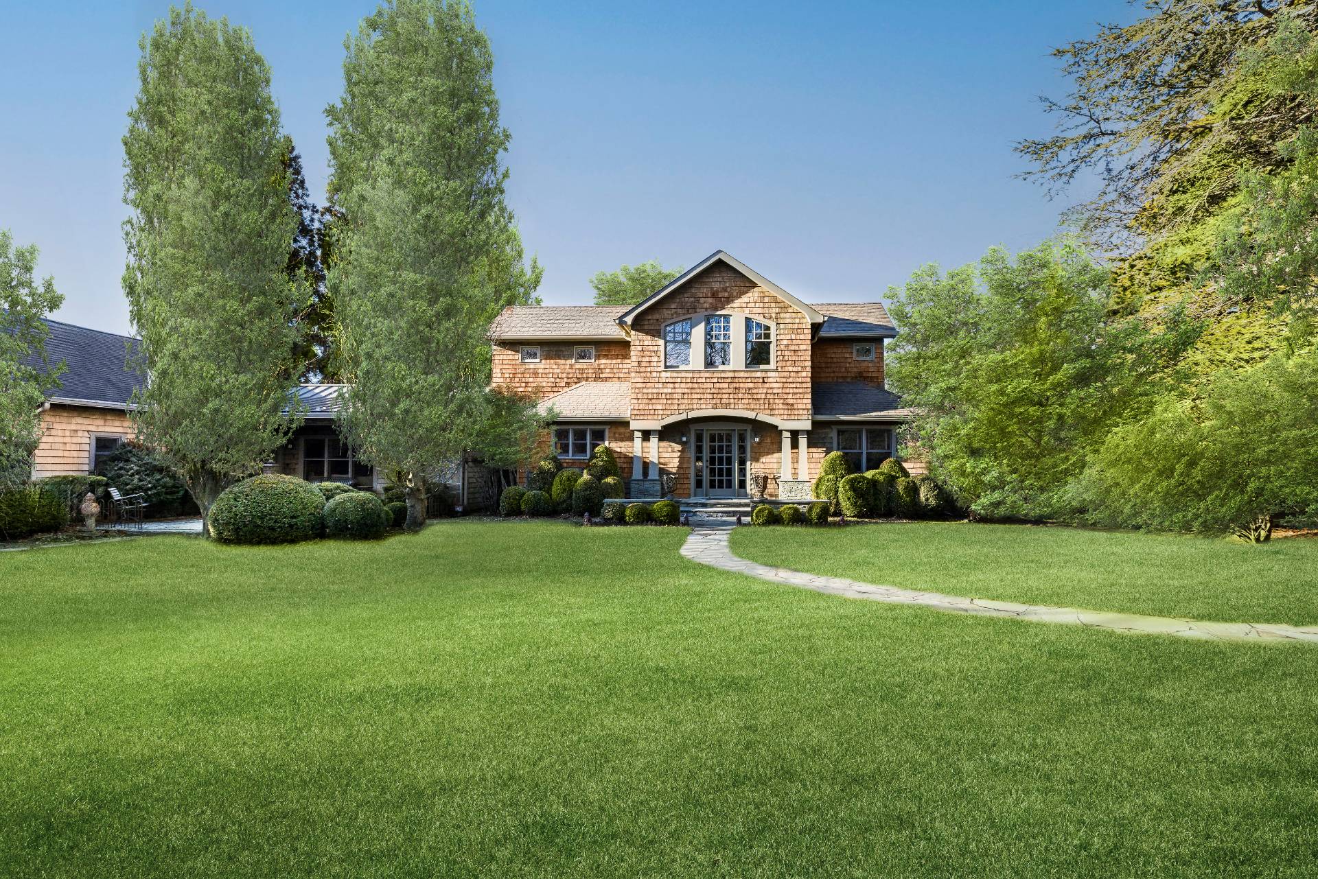 488 Lumber Lane Bridgehampton, NY 11932 - Photo 2 of 21 a front view of a house with a yard and garage
