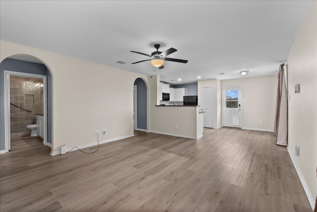 5727 Treasure Cove Road Cove, TX 77523 - Photo 6 of 20 wooden floor in an empty room with a kitchen