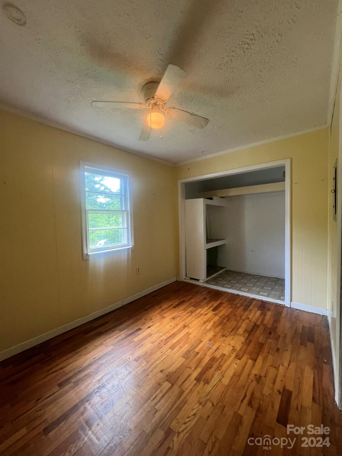 1323 Locust Grove Road Hendersonville, NC 28792 - Photo 15 of 40 a view of empty room with wooden floor and fan