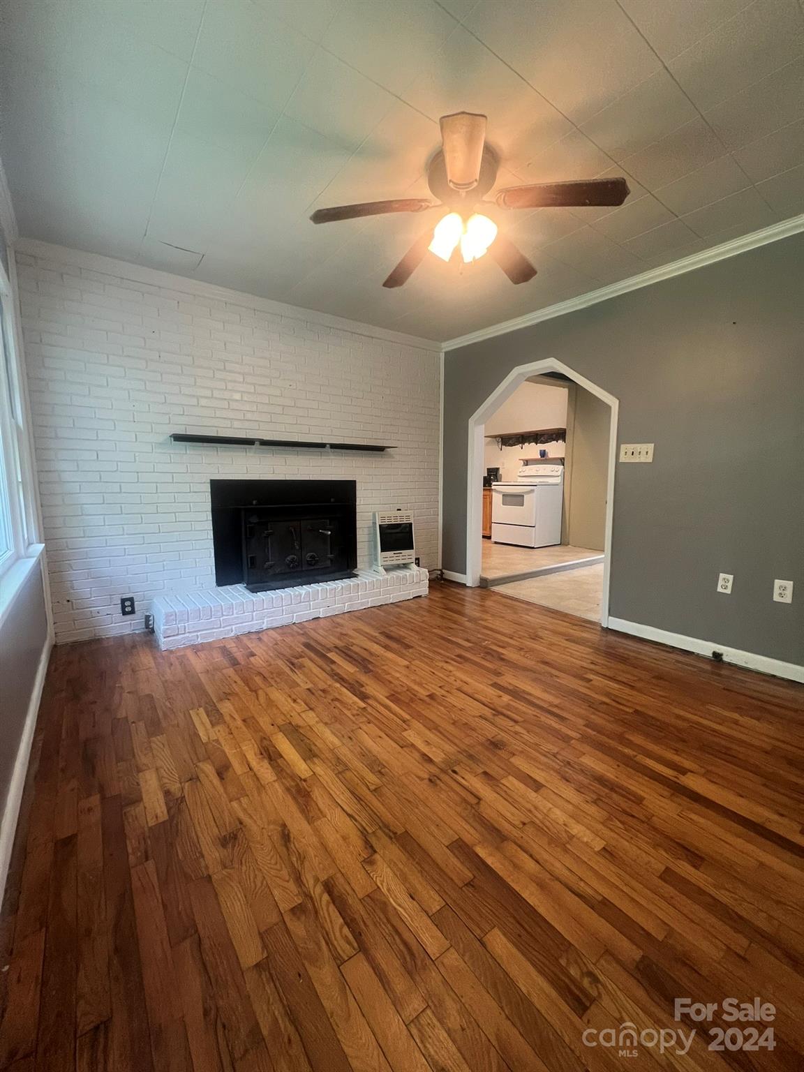 1323 Locust Grove Road Hendersonville, NC 28792 - Photo 17 of 40 a bedroom with a bed and a chandelier
