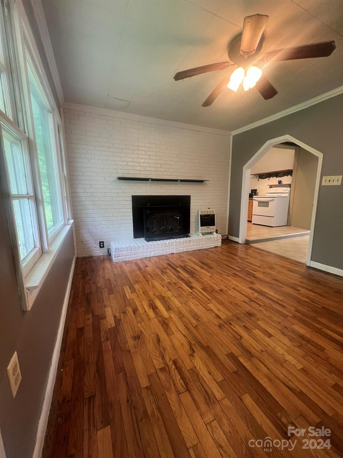 1323 Locust Grove Road Hendersonville, NC 28792 - Photo 18 of 40 a view of empty room with a fireplace and wooden floor